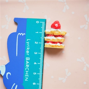 Detailed macro view showing the size of the miniature resin strawberry layer cake model