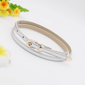Detail of white PU leather skinny belt with golden D-ring buckle on white background