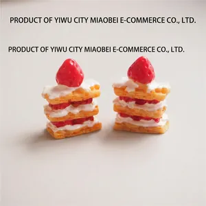 Macro view of miniature strawberry napoleon cake models with layered resin cream and fruit