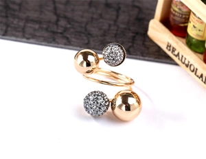 Detail of gold spiral ring with polished spheres and shimmering micro-set crystal stones