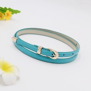Detail of turquoise PU leather skinny belt with golden buckle and floral accents