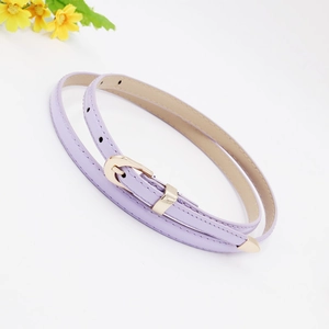 Close-up of lavender thin PU leather belt with gold metal buckle and tip on white surface