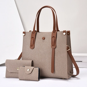Three-piece tote bag set in woven canvas and brown leather with gold hardware