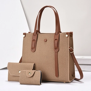 Three-piece woven canvas tote bag set with brown faux leather trim and gold hardware