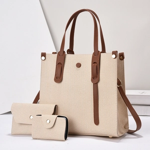 Three-piece woven tote bag set with brown leather trim and elegant minimalist design