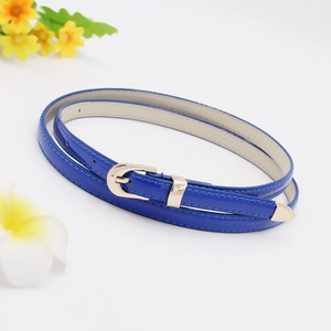 Detail of slim blue leather belt with polished gold metal buckle and elegant finish