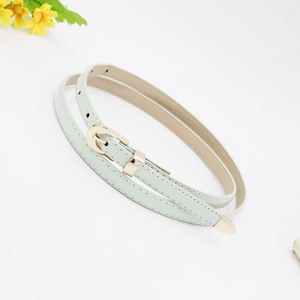 Close-up of mint green thin leather belt with gold pin buckle on white background