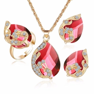 Detailed view of red teardrop crystal jewelry set with gold plating and zircons