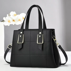 Elegant black lychee textured quilted handbag with gold hardware and shoulder strap