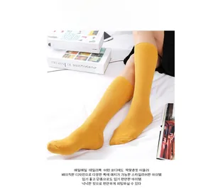 Detail of ginger yellow ribbed knit slouch socks in soft cotton fabric for a vintage look