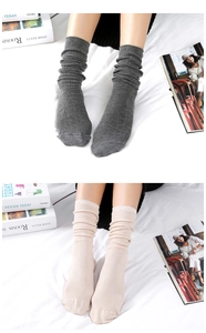 Detail of grey and beige ribbed knit slouch socks showing soft textured fabric