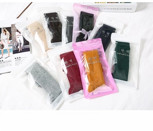 Multi-color pack of slouch socks in individual branded transparent packaging
