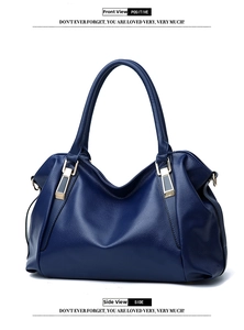 Detail view of navy blue tote bag featuring litchi grain texture and gold hardware