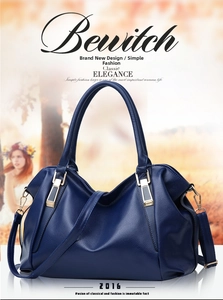 Detailed view of the dark blue lychee texture leather and gold metal hardware on the tote bag