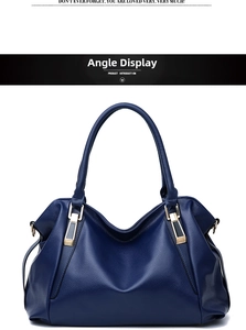 Detail of navy blue pebble leather tote bag with elegant gold hardware and top handles