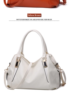 Detail view of lychee texture leather bags in white and tan colors with golden hardware