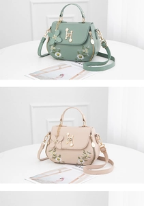 Detail of daisy embroidery and H-shaped metal buckle on mint green and beige handbags