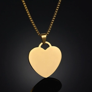 Polished gold heart dog tag pendant necklace with box chain on a black background