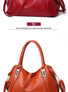 Close-up of burgundy leather texture and golden hardware on a women's tote bag