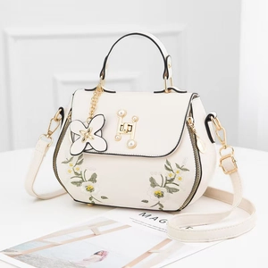 Elegant white PU leather handbag with floral embroidery and pearl H-clasp closure
