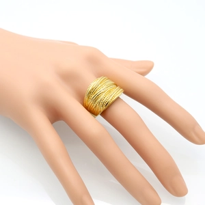 Detail of wide gold stackable stainless steel ring with textured bead and line engravings