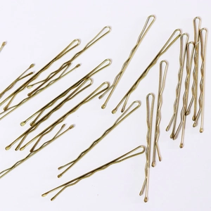 Set of 16 golden wave-shaped U-hairpins in minimalist metal style on white background