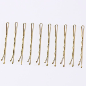 Detailed view of ten golden wavy metal hair pins arranged on a clean white background