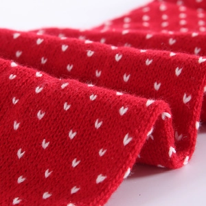 Thick knitted red winter scarf with white heart patterns and soft texture