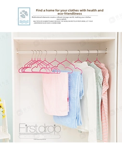 Detailed view of heavy-duty rose pink anti-slip metal hangers in a minimalist white closet