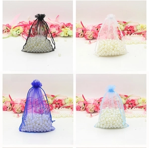 Detail of colorful organza drawstring bags in black white and blue for gift packaging