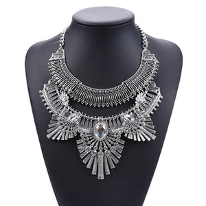 Detail of bohemian layered necklace with ancient silver finish and faux gemstone charms