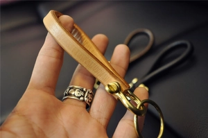 Close-up of premium leather keychain with brass horseshoe buckle in vintage style
