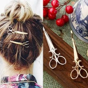 Detailed view of creative scissor-shaped alloy hair clips in gold and silver finishes