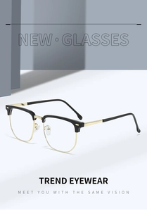 Detail view of half-rim black and gold eyeglasses frame with metallic rivets and textures