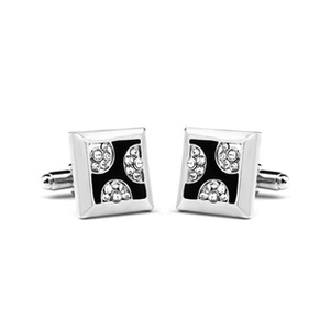 Detail of silver crown cufflinks with black enamel inlay and clear crystal embellishments