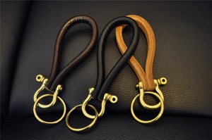 Three premium handmade leather keychains with vintage brass D-rings in multiple colors