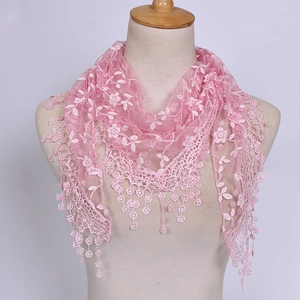 Detailed embroidery and lace edges with soft ball tassels on a pink triangular scarf