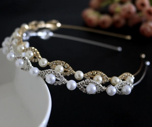 Detail of gold and silver wavy headbands with pearls and rhinestones on a white edge