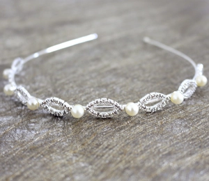 Detail of silver bridal headband with sparkling rhinestones and elegant faux pearls