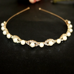 Close-up detail of golden metal headband with elegant pearls and sparkling rhinestones