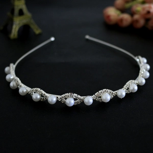 Detail shot of silver bridal headband with sparkling rhinestones and elegant white pearls