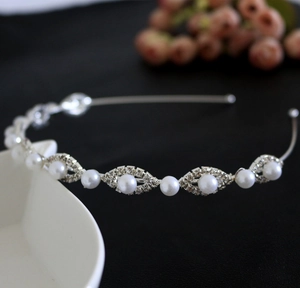 Detailed view of bridal headband featuring marquise rhinestones and round pearls on silver metal