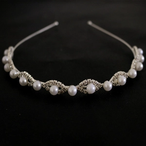 Detailed macro view of silver headband with pearls and sparkling wavy rhinestones