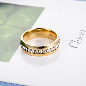 Close-up of a gold-plated titanium ring with a single row of sparkling crystal zircons