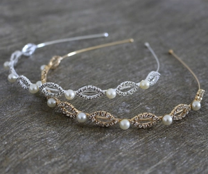 Close-up of elegant gold and silver bridal headbands with pearls and crystals