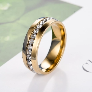 Macro shot of gold stainless steel ring featuring a brushed finish and a row of zircon stones
