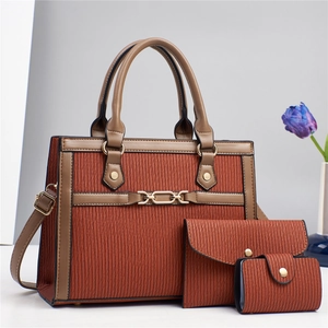 Three-piece set of brick red textured leather handbags with chain link and gold hardware