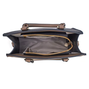 Top view of two-tone crossbody bag showing large main compartment and zipper divider