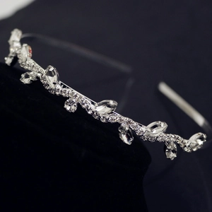 Macro detail of leaf-shaped rhinestone headband with sparkling silver crystal embellishments
