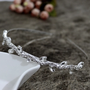 Close-up of elegant silver wide headband with sparkling rhinestones in a leaf pattern